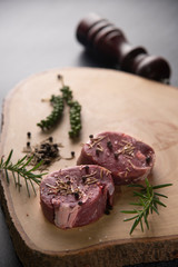 raw beef steak on wooden cutting board