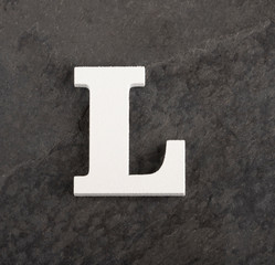 Letter L from blank alphabet on gray background - Top view
