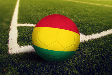 Bolivia ball on corner kick position, soccer field background. National football theme on green...
