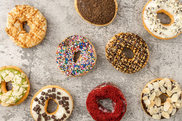 food background of assortment ofood background of assortment of donuts on stone backgroundf donuts on orange background