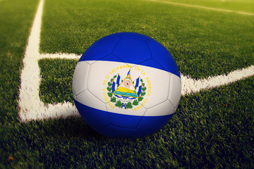 El Salvador ball on corner kick position, soccer field background. National football theme on green...
