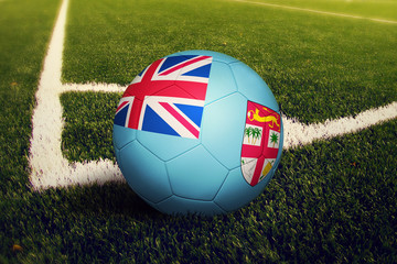 Fiji ball on corner kick position, soccer field background. National football theme on green grass.