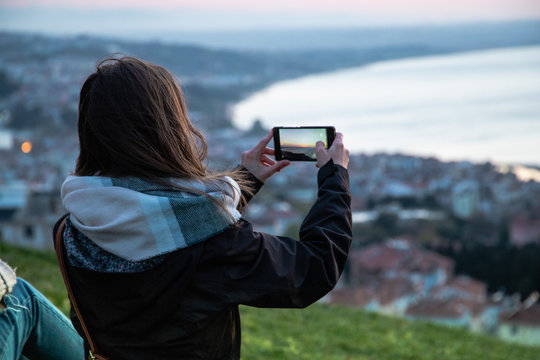 Girl taking photo in sinop sunset in turkey