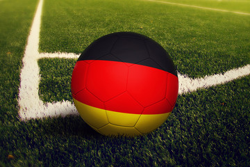 Germany ball on corner kick position, soccer field background. National football theme on green...