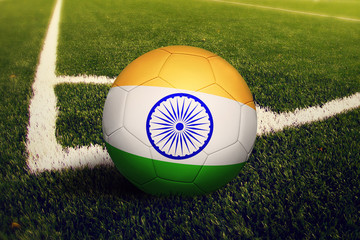 India ball on corner kick position, soccer field background. National football theme on green grass.