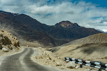 Fototapeta na wymiar Beautiful Landscape of Road on the way in the hill with snow mountain background this way go to Nubra Valley, Leh Ladakh, India