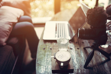 The Vlogger in the studio cafe or house studio enjoying with footage in the laptop