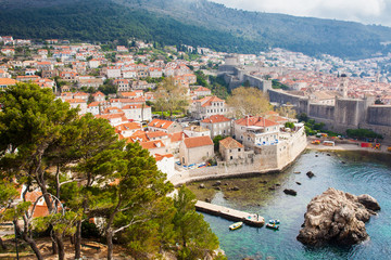 Fototapeta na wymiar Dubrovnik West Pier and medieval fortifications of the city seen from Fort Lovrijenac