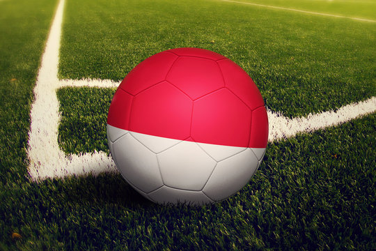 Monaco ball on corner kick position, soccer field background. National football theme on green grass.
