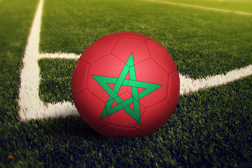 Morocco ball on corner kick position, soccer field background. National football theme on green...