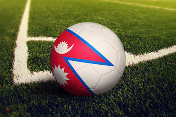Fototapeta na wymiar Nepal ball on corner kick position, soccer field background. National football theme on green grass.