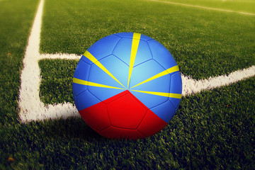 Reunion ball on corner kick position, soccer field background. National football theme on green...
