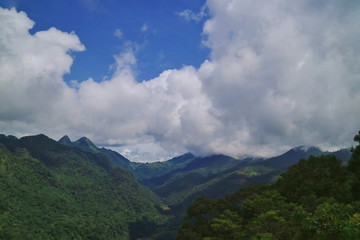 Beautiful landscape view of the mountains with clouds and blue sky in the countryside of Thailand.