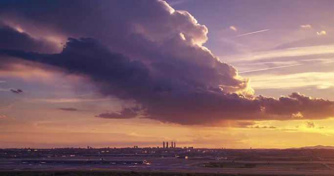 Sunset seen from Paracuellos del Jarama. Timelapse of Madrid skyline with beautiful sunset and impressive storm clouds. Madrid airport and 4 towers bussines area as main subject.