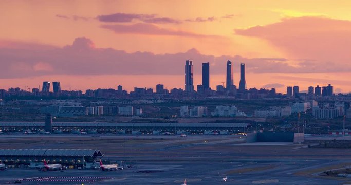 Sunset seen from Paracuellos del Jarama. Timelapse of Madrid skyline with beautiful sunset and impressive storm clouds. Madrid airport and 4 towers bussines area as main subject.