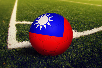 Taiwan ball on corner kick position, soccer field background. National football theme on green...