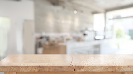Wood table for product display montage in blurred cafe background