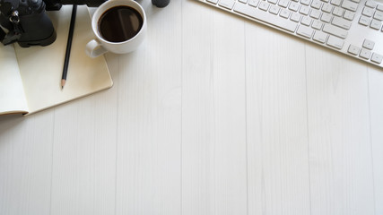 White designer office desk table with PC, supplies and copy space.
