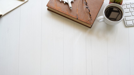 Top view white wood workspace with home office supplies and copy space