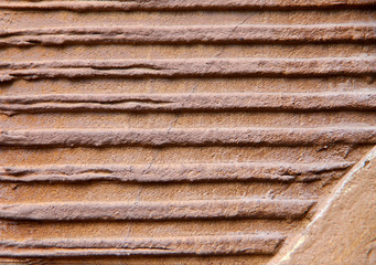 Abstract blurred background. The texture of the brown surface with convex horizontal lines. Cropped shot, horizontal, nobody, top view, plenty of space for text. Concept design and construction.