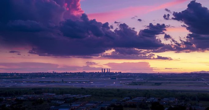 Sunset seen from Paracuellos del Jarama. Timelapse of Madrid skyline with beautiful sunset and impressive storm clouds. Madrid airport and 4 towers bussines area as main subject.