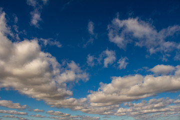 Sky of abundant white clouds and celestial spaces. Cottony clouds distributed throughout the sky.