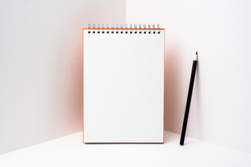 orange spiral notebook with white page on 3D space