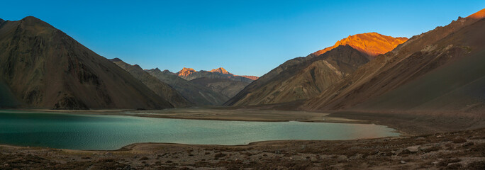 Embalse del Yeso (Yeso Dam) awe high altitude turquoise waters lake inside an amazing rugged landscape. Steep mountains on an awe scenery with the river stopped by the dam inside a valley surrounded b