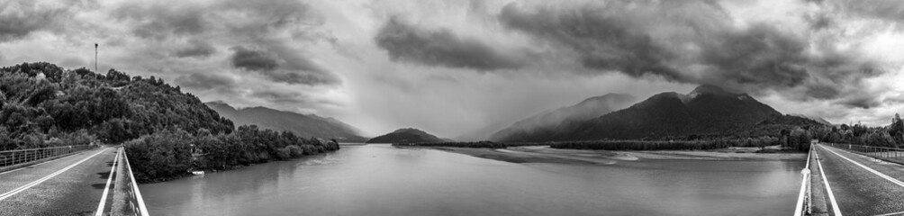 A dramatic view of North Patagonia landscapes, bad autumn weather with an overcast and stormy day full of clouds bringing rain to the amazing scenery. An awe road trip around Reloncavi estuary 