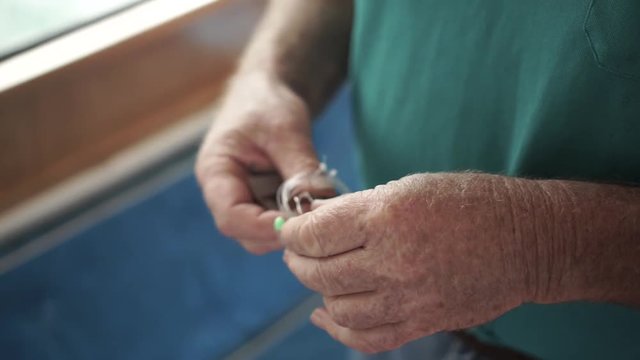 SLOWMO - Close up of man prepping fly fishing line