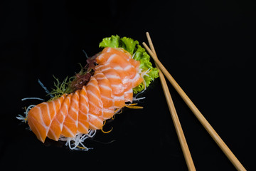 Salmon Sashimi on Black Ceramic Plat,black background.