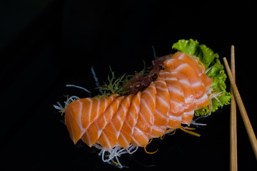 Salmon Sashimi on Black Ceramic Plat,black background.