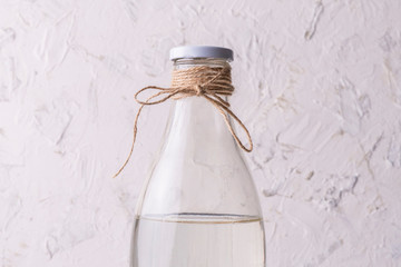 glass bottle with absolutely clean distilled water isolated on grunge surfaces