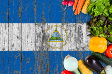 Fresh vegetables from Nicaragua on table. Cooking concept on wooden flag background.