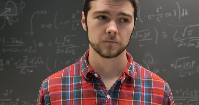 Nervous anxious young man twitching in front of a complex math problem
