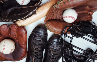 A group of vintage baseball equipment on a wooden background. Jersey is from a high school jersey...