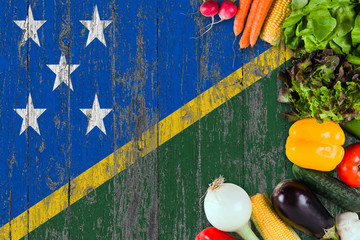Fresh vegetables from Solomon Islands on table. Cooking concept on wooden flag background.