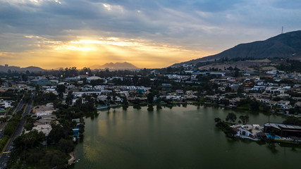 Lima, Perú - May 4 2019:  Aerial view of Las Lagunas in La Planicie. Lake at sunset with houses of high class.
