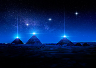 Sci-fi 3D rendering or illustration of Egyptian pyramids at night shooting light rays from the tips