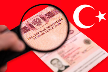 Observing Russain foreign passsport through a magnifying glass.
