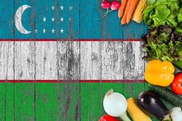 Fresh vegetables from Uzbekistan on table. Cooking concept on wooden flag background.