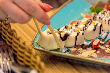 Marshmallow rolls served with peanuts and strawberries