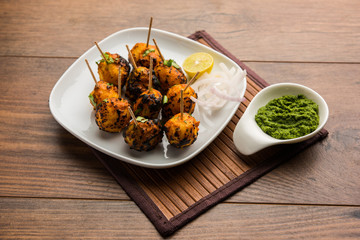 Tandoori aloo are roasted potatoes with Indian spices. It's a party appetiser served with green chutney. selective focus