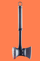 Kitchen multifunctional ax for cutting meat and forming chops on a coral background.