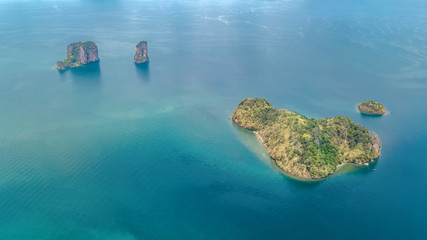 Fototapeta na wymiar Aerial drone view of tropical islands, beaches and boats in blue clear Andaman sea water from above, beautiful archipelago islands of Krabi, Thailand