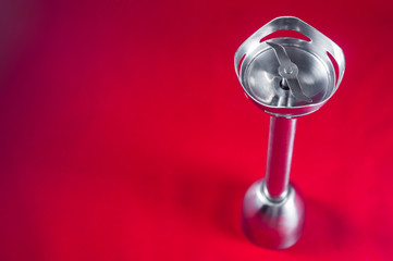 Iron nozzle for kitchen blender on red background