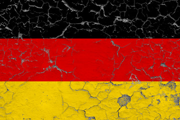 Flag of Germany painted on cracked dirty wall. National pattern on vintage style surface.