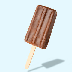 Chocolate popsicle on the sticks, frozen juice. Bright color, summer mood. Ice cream, freshness, Isolate, on a blue background