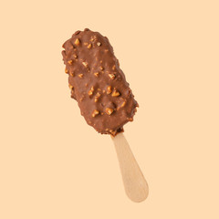 Chocolate popsicle on the sticks, ice cream in milk chocolate and with a wink. Bright color, summer mood. Ice cream, freshness, Isolate, on an orange background