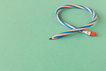 Flexible pencil . Isolated on light background. Bending pencil.